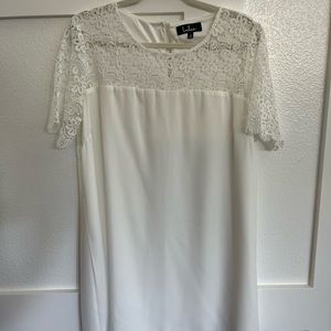 Lulu’s white crepe dress with lace sleeves.